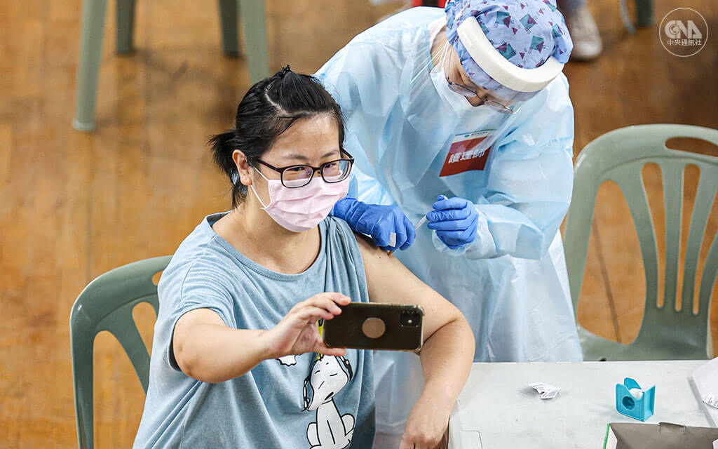 6月起各縣市陸續開放大規模接種,台北市在花博爭艷館、中正紀念堂等大型場所施打疫苗。民眾接種時表情各異,有人露出害怕表情,也有人拿出手機自拍留念。