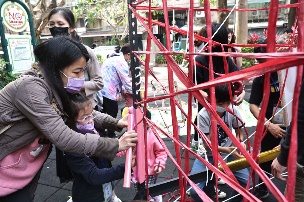 接著，孩子與家長一起試著把模型具象化，搭建在鐵架上。