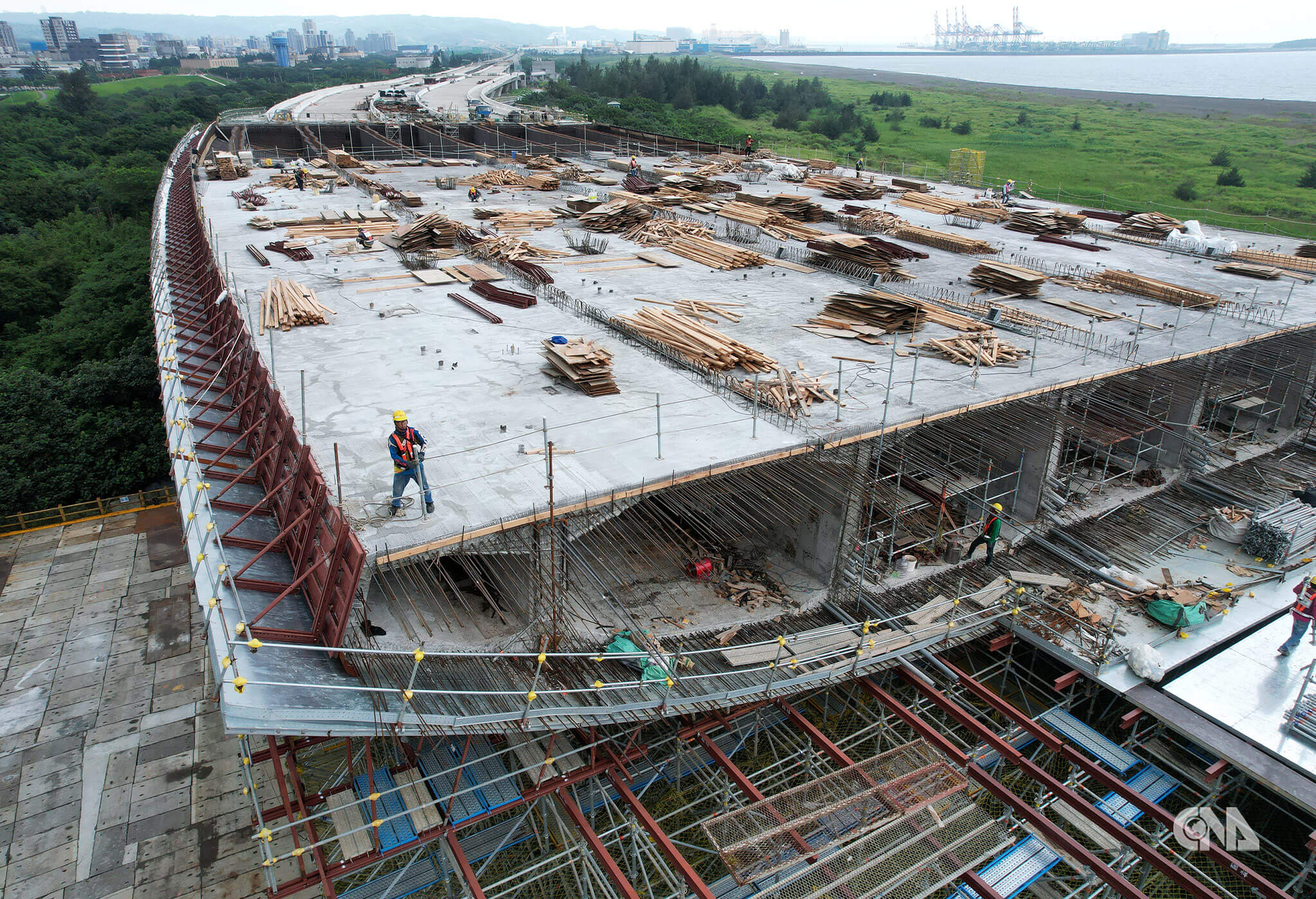 八里端匝道橋面施工，遠望台北港與海岸。